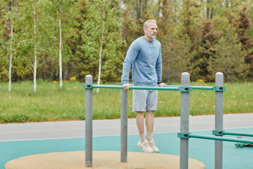 Senior podczas treningu w hotelowym parku street workout